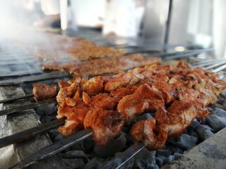 Shashlik preparing on a barbecue grill over charcoal. Shashlik or Shish kebab popular in Eastern Europe.