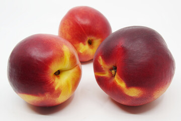 Three nectarines on white background. Nectarine fruit isolated on white background