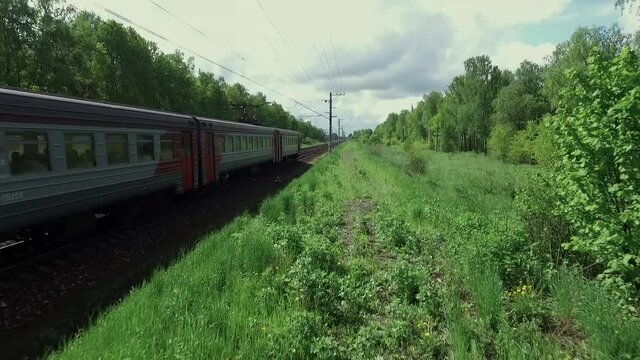 A parallel survey of red and grey train. Dolly camera shot