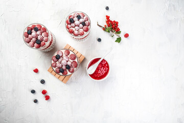 Vegetarian breakfast, bowls with organic granola, fresh raspberries and blueberries and yoghurt. banner, catering menu recipe place for text, top view