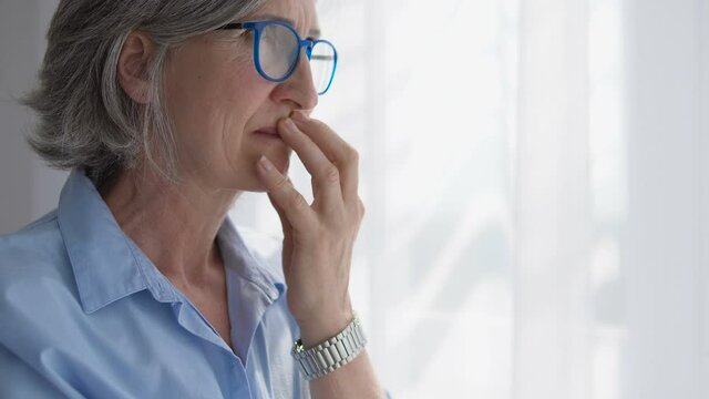 Senior woman thinking over difficult situation in her life, family problems