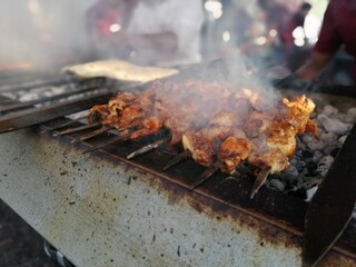 Shashlik preparing on a barbecue grill over charcoal. Shashlik or Shish kebab popular in Eastern Europe.