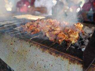 Shashlik preparing on a barbecue grill over charcoal. Shashlik or Shish kebab popular in Eastern Europe.