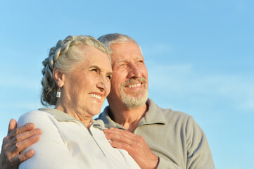 Close-up portrait of happy senior couple hugging