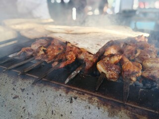 Shashlik preparing on a barbecue grill over charcoal. Shashlik or Shish kebab popular in Eastern Europe.