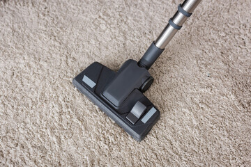 Top view of brush of vacuum cleaner on carpet