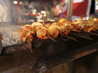 Shashlik preparing on a barbecue grill over charcoal. Shashlik or Shish kebab popular in Eastern Europe.