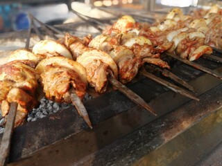 Shashlik preparing on a barbecue grill over charcoal. Shashlik or Shish kebab popular in Eastern Europe.