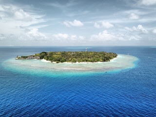 Maldives: Tropical Desert Island from Above, with White Sand Beach, Palm Trees, Turquoise Sea, Blue Sky and Dramatic Clouds (Bandos Maldives, North Male Atoll, Indian Ocean) DJI Mavic Pro Drone