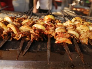 Shashlik preparing on a barbecue grill over charcoal. Shashlik or Shish kebab popular in Eastern Europe.