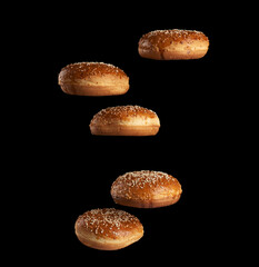 baked round sesame buns for sandwiches and hamburgers levitate