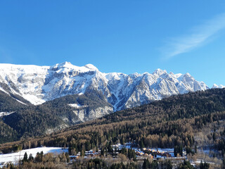 Snowy mountain Dolomiti landscape with blue sky.