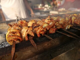 Shashlik preparing on a barbecue grill over charcoal. Shashlik or Shish kebab popular in Eastern Europe.