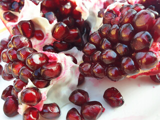 Macro of pomegranate seeds. A broken red pomegranate.