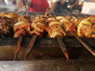 Shashlik preparing on a barbecue grill over charcoal. Shashlik or Shish kebab popular in Eastern Europe.