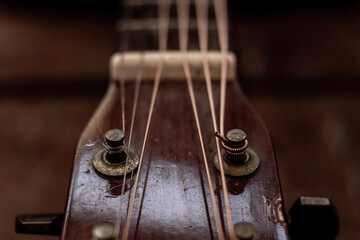 Head stock of old acoustic guitar. Vintage style photo