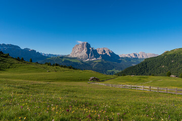 Beautiful alpine countryside. Awesome Alpine landscape with traditional huts. Amazing Nature Scenery of Dolomites Alps. Epic Scene in the mountains place near Seceda peak. Val Gardena. Dolomiti alp.