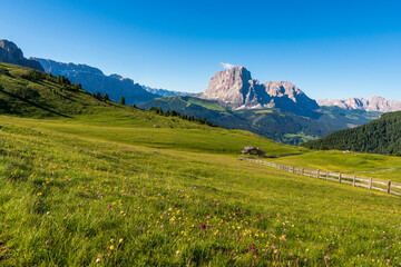 Beautiful alpine countryside. Awesome Alpine landscape with traditional huts. Amazing Nature Scenery of Dolomites Alps. Epic Scene in the mountains place near Seceda peak. Val Gardena. Dolomiti alp.