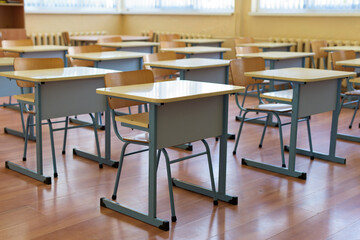 Empty classroom with rows of desks - basic colors yellow and blue