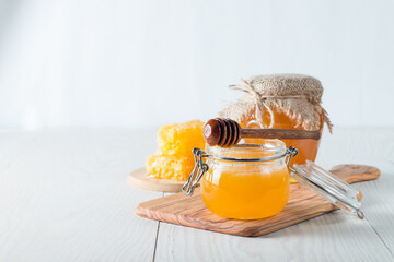 Honey in a jar on wooden rustic background