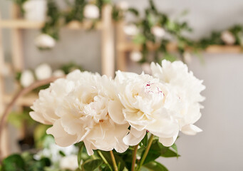 Floral background. Flower shop interior. Floral design studio, making decorations and arrangements. Flowers delivery service and sale of home plant, creating order. Peonies and roses.
