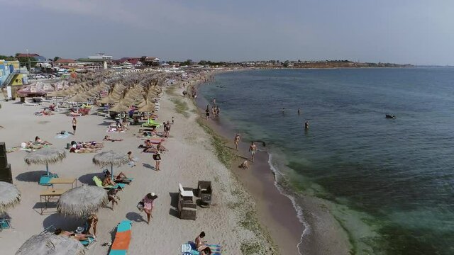 People sunbathing at Vama Veche - serial footage, Romania,  May 2018.