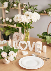 Wedding invitation card. Romantic candlelight dinner. Wedding table decor. Valentine's Day 14th of February. Background with flowers roses and peonies. Festive table setting. Wedding decor