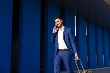 Young executive businessman walking around the airport for work trip