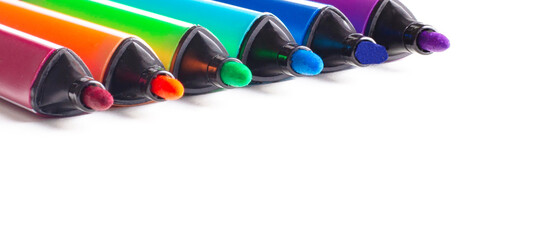 Multi-colored felt-tip pens on a white background close-up. Top view.