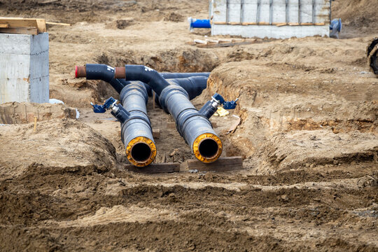 New black pipes laying in the ground