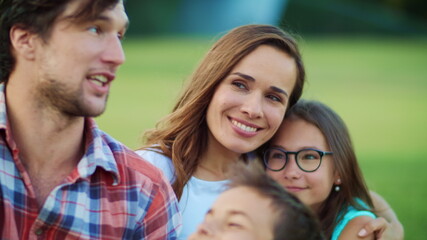 Happy kids and parents using mobile phone for video call outdoors
