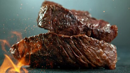 Close-up of falling tasty beef steak, super slow motion, filmed on high speed cinematic camera at 1000 fps.