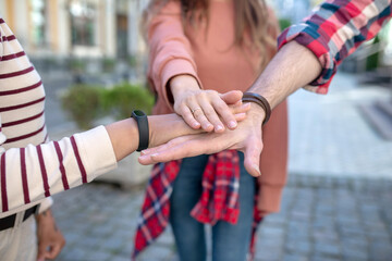 Male hand and two female gestures showing fidelity to friendship