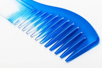 blue plastic comb on white background