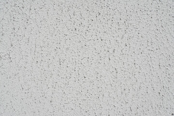 Part of the texture of a white wall decorated with decorative putty