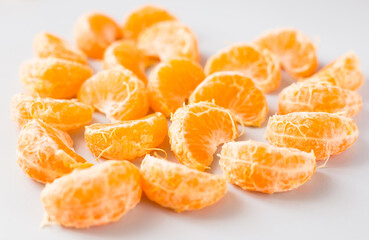delicious peeled mandarin slices on white background