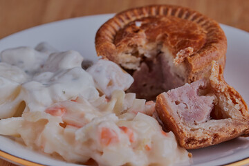 Pork pie with coleslaw and potato salad.