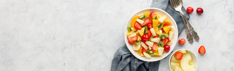 Fresh chopped fruit salad in a bowl. Long banner format.