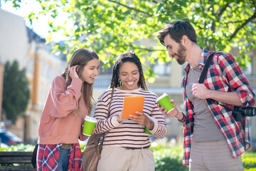 Girl with tablet girlfriend with guy next to coffee