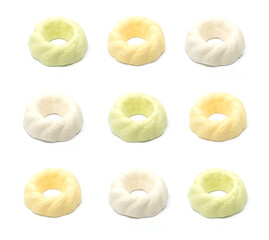Meringue on a white isolated background, multiple colored green / orange and white Christmas candies, lie in a pattern