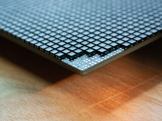 Closeup of corner of an LED video screen with shallow depth of field and some emitters removed