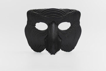 A black wooden mask on a white background.