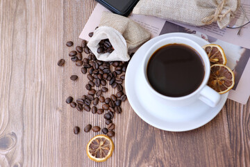 Top view coffee cup and coffee beans on wooden table background and space for text 