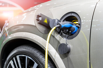 EV Car or Electric car at charging station with the power cable supply plugged, Charging vehicle technology industry transport, EV fuel Plug in hybrid car..