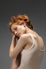 Dreams. Fashion portrait of beautiful redhead woman isolated on grey studio background. Concept of beauty, skin care, fashion and style. Artwork, modern and trendy portrait. Attractive model.