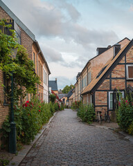 Fototapeta na wymiar A cosy cobblestone street with half-timbered houses in the old parts of the medieval university city of Lund, Sweden