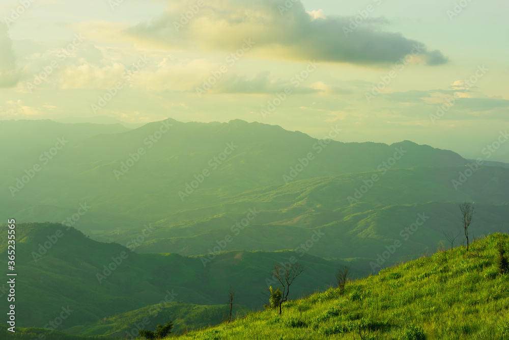 Canvas Prints sunset and mountains interspersed with green grass