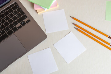 Blank notebook with laptop on office desk table. Concept of online work or education. Top view