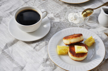 breakfast with black coffee and tasty cheese pancakes