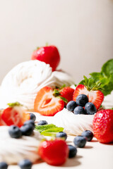 Dessert pavlov with strawberries and blueberries